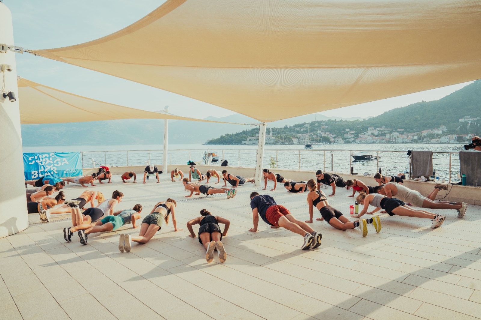 SurfYogaBeer group workout by the sea after the summit hike in Croatia