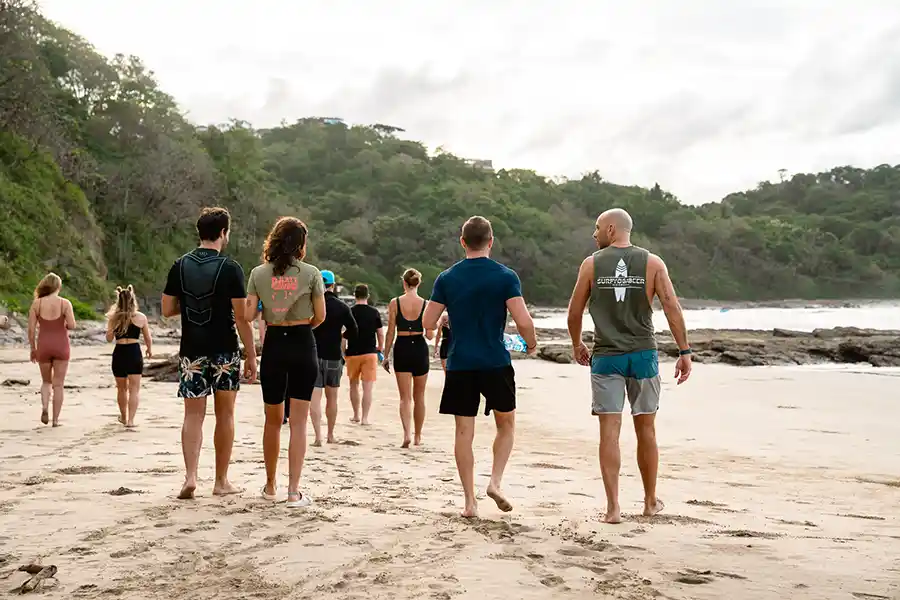 SurfYogaBeer group walking on the beach in Nicaragua