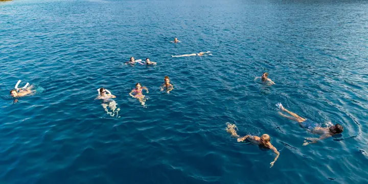 Group swimming in a deep blue bay on the SYB Turkey trip