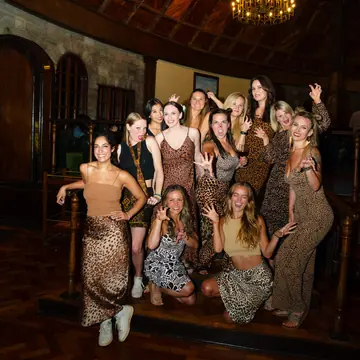 The crew dressed in animal print for theme night at the lodge on the SYB Kenya trip