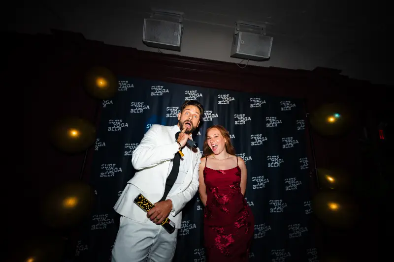A white tux and a red dress at the photo wall