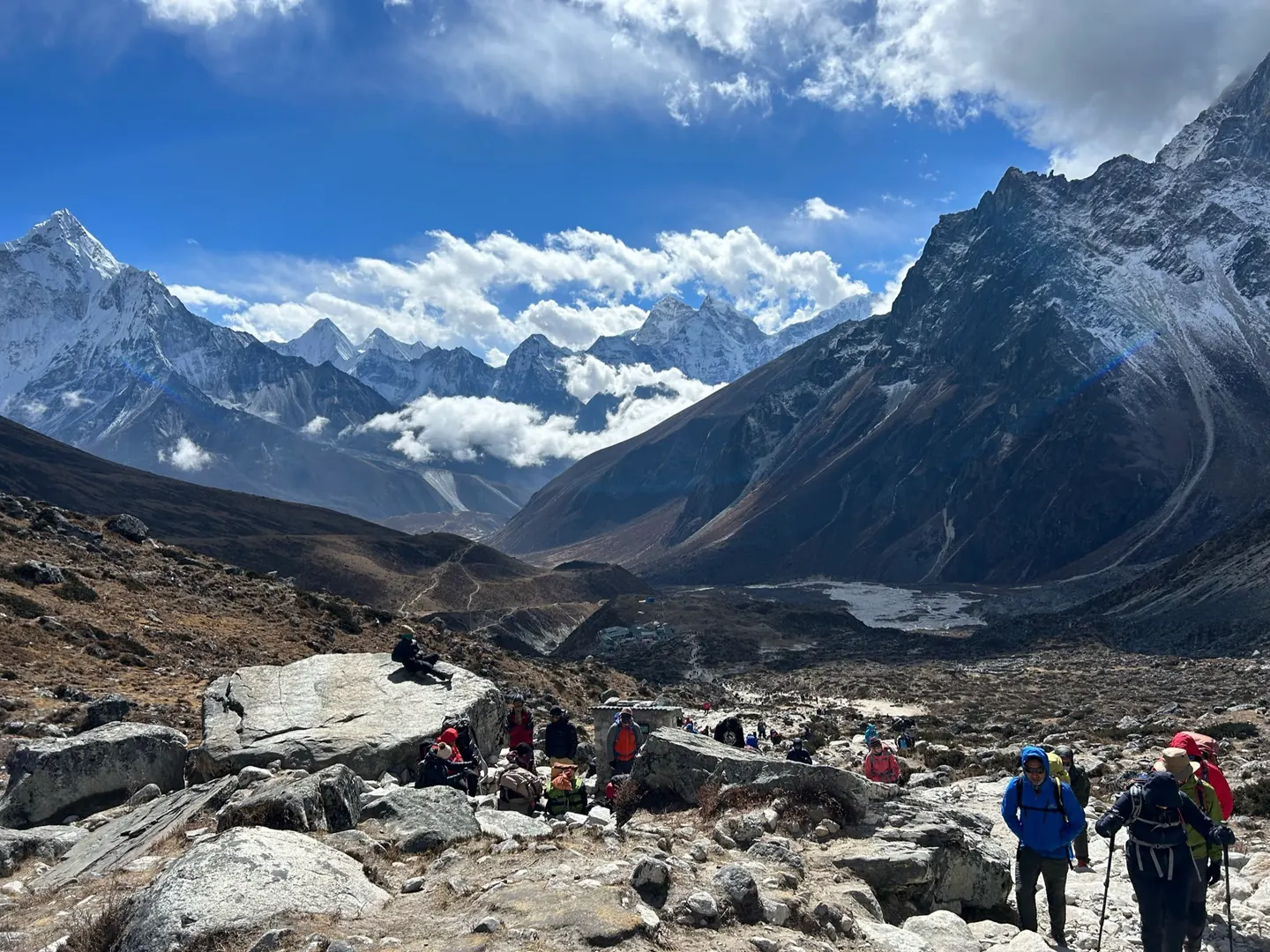 Hardest Adventures trekkers resting with a view of Ama Dablam on the trek to Everest Base Camp.