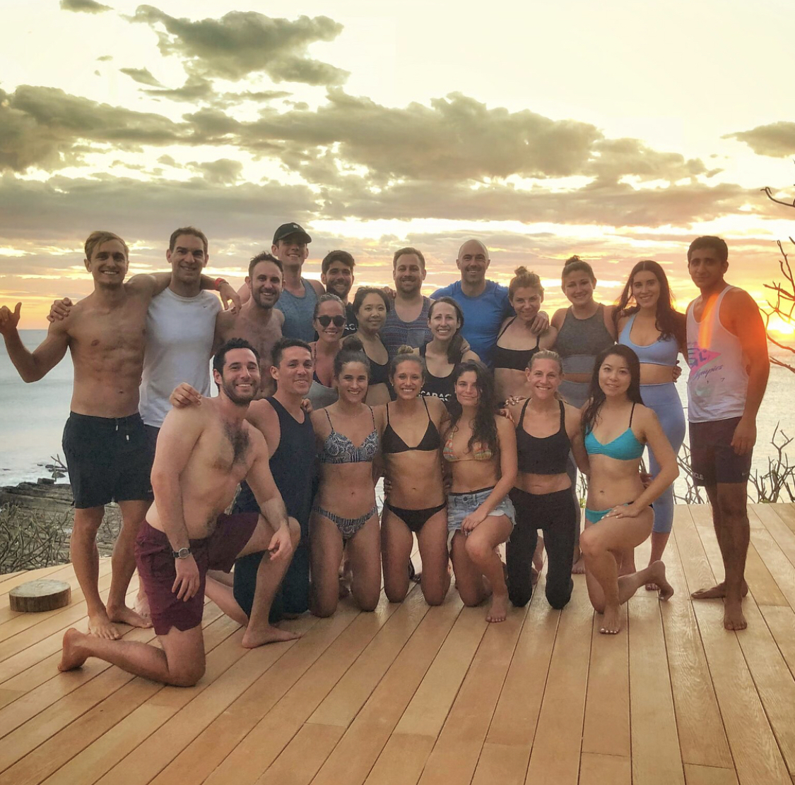 An SYB group in swimwear smiling together on a deck at sunset in Nicaragua