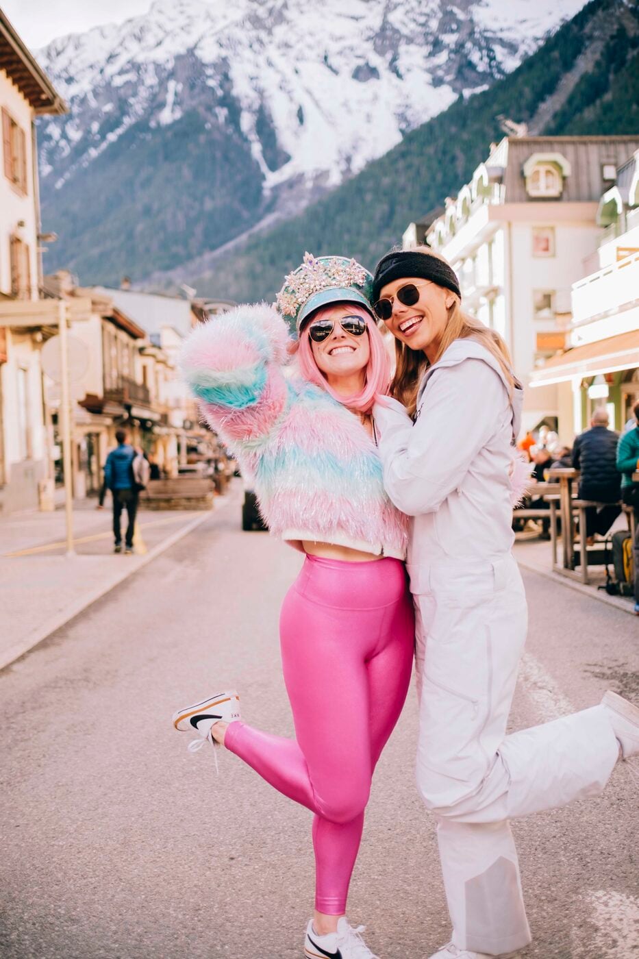 Two travelers in ski outfits posing on a street in Chamonix