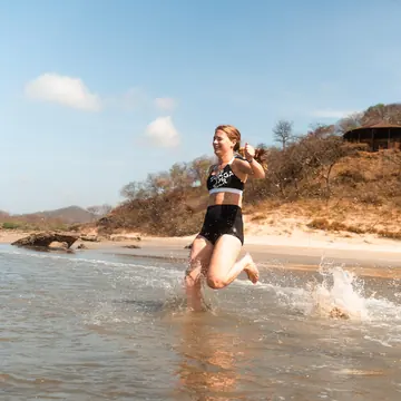 Jumping into a tide pool on the beach