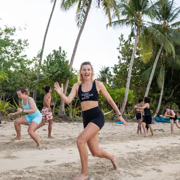 Squat jumps on the beach under the palm trees on the SYB Philippines trip