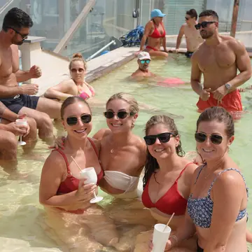 Group in the pool with drinks on the SYB Dolomites trip
