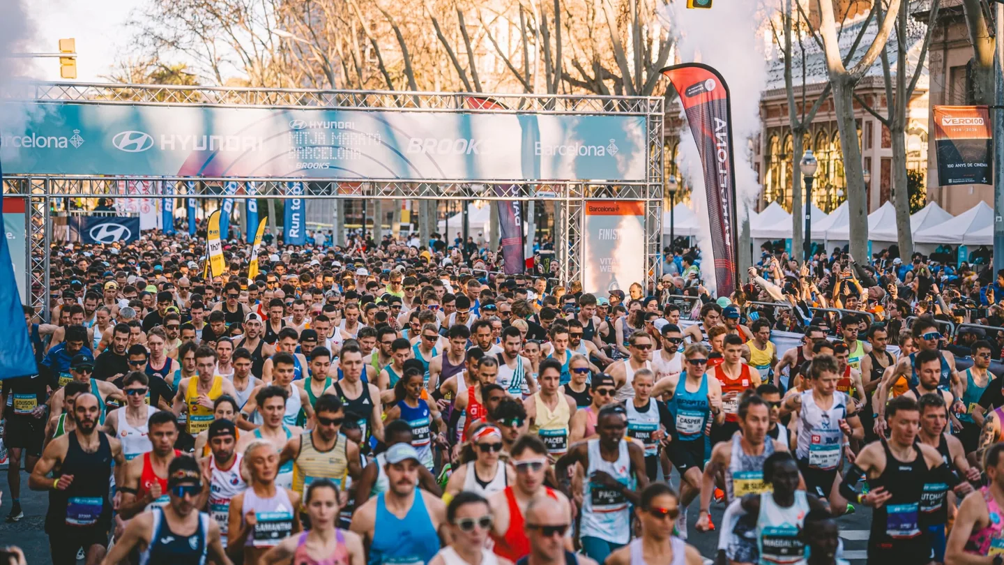 Thousands of runners packed beneath the start gantry at the Barcelona Marathon on race morning.