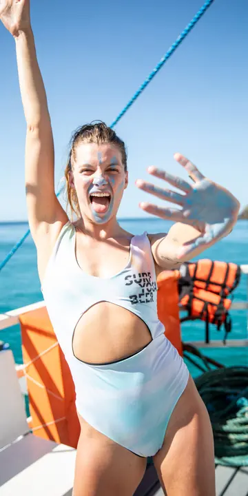 Cheering with both arms up on the boat on the SYB Philippines trip