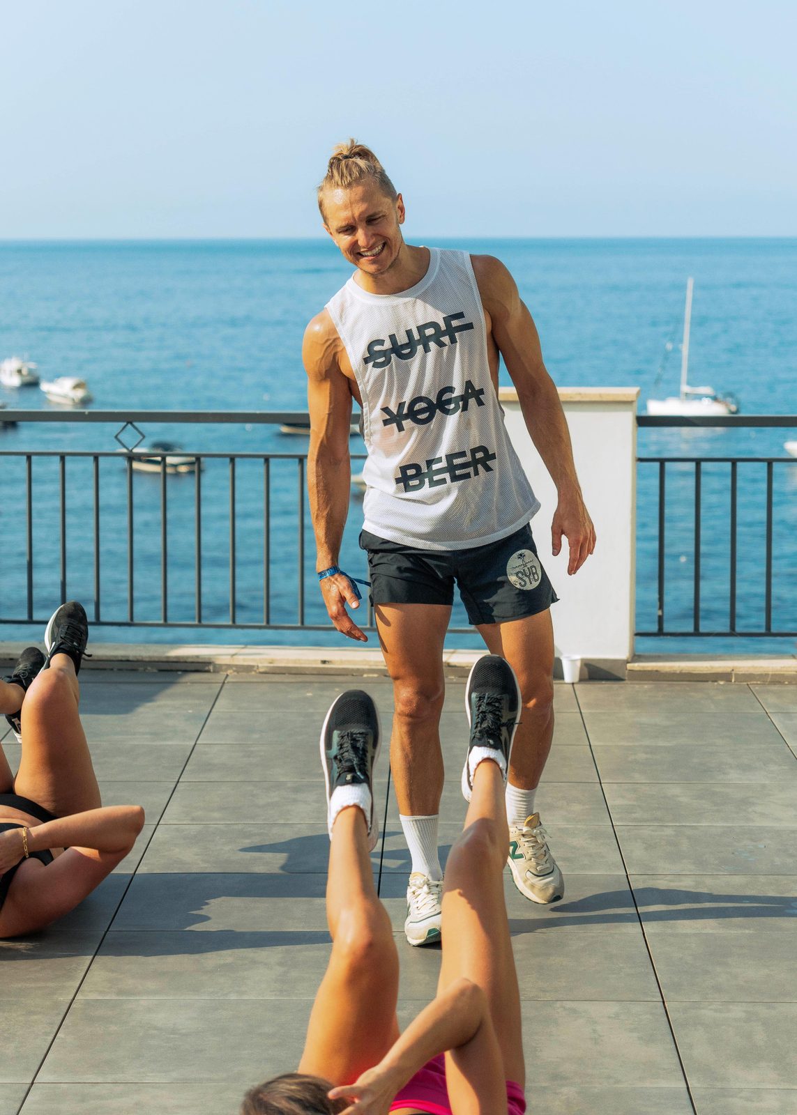 Mantas leading a workout on a terrace above the sea