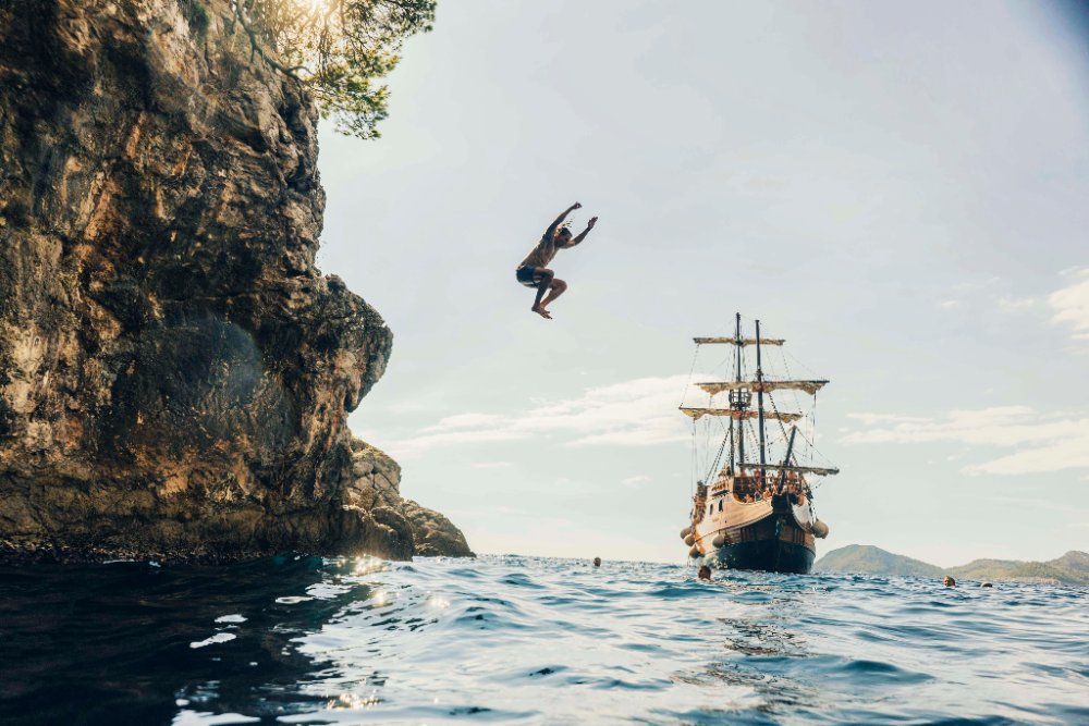 Cliff jumping beside the SurfYogaBeer pirate ship in Croatia
