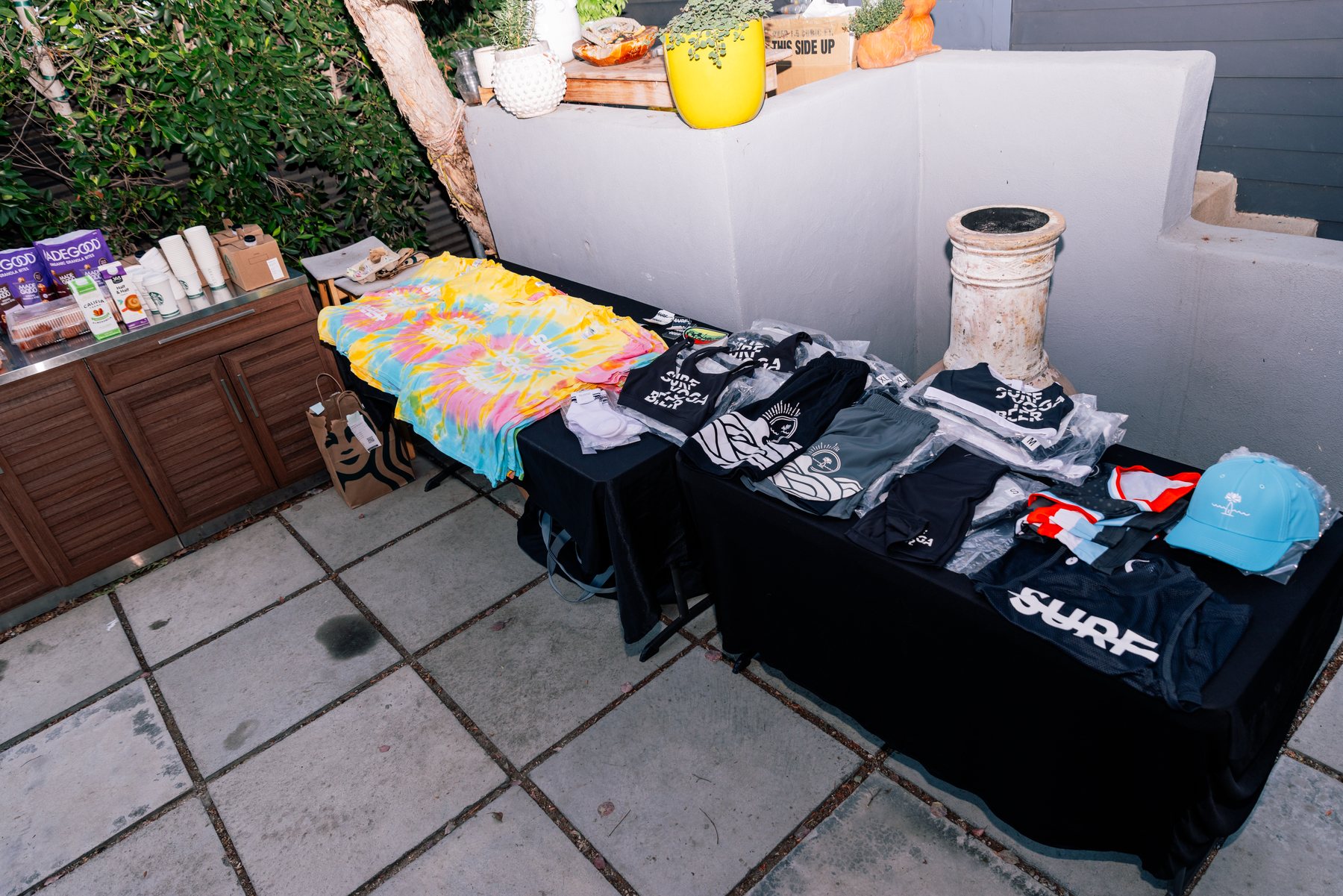 SYB x LT Days shirts laid out on the merch table