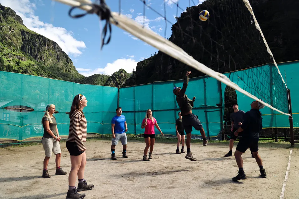 Trekkers playing volleyball on a village court in the Khumbu valley before the climb to Namche