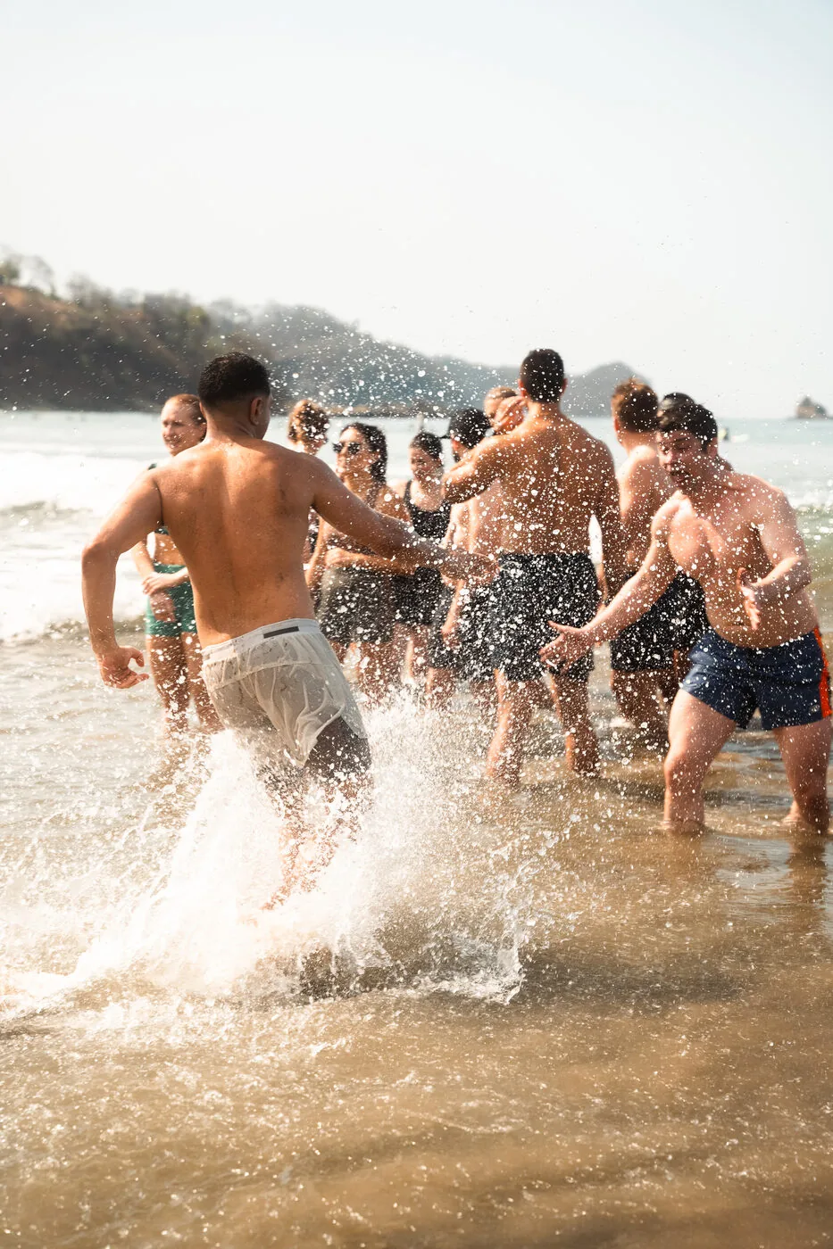 SYB travelers running into the ocean together at Playa Maderas