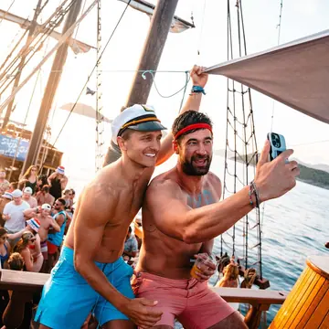 Two friends in captain hats taking a selfie on the wooden ship on the SYB Croatia trip