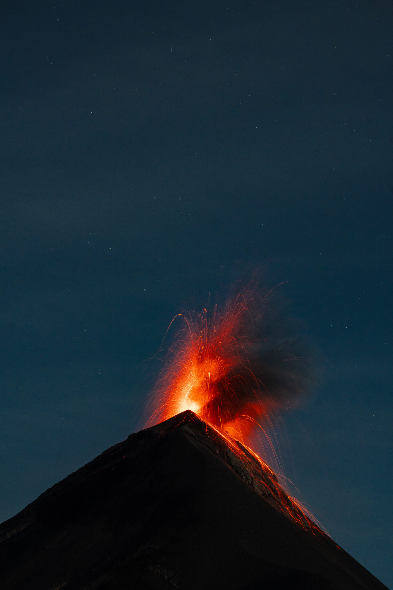 Fuego erupting at night seen from the Acatenango ridge
