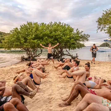 Sit ups in a circle on the beach on the SYB Philippines trip