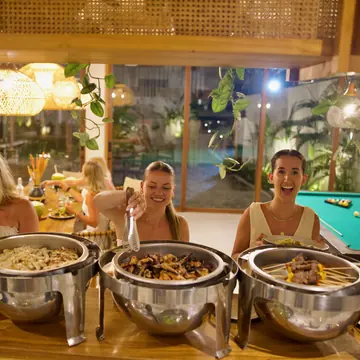 Guests serving themselves at a buffet dinner on the SYB Bali trip