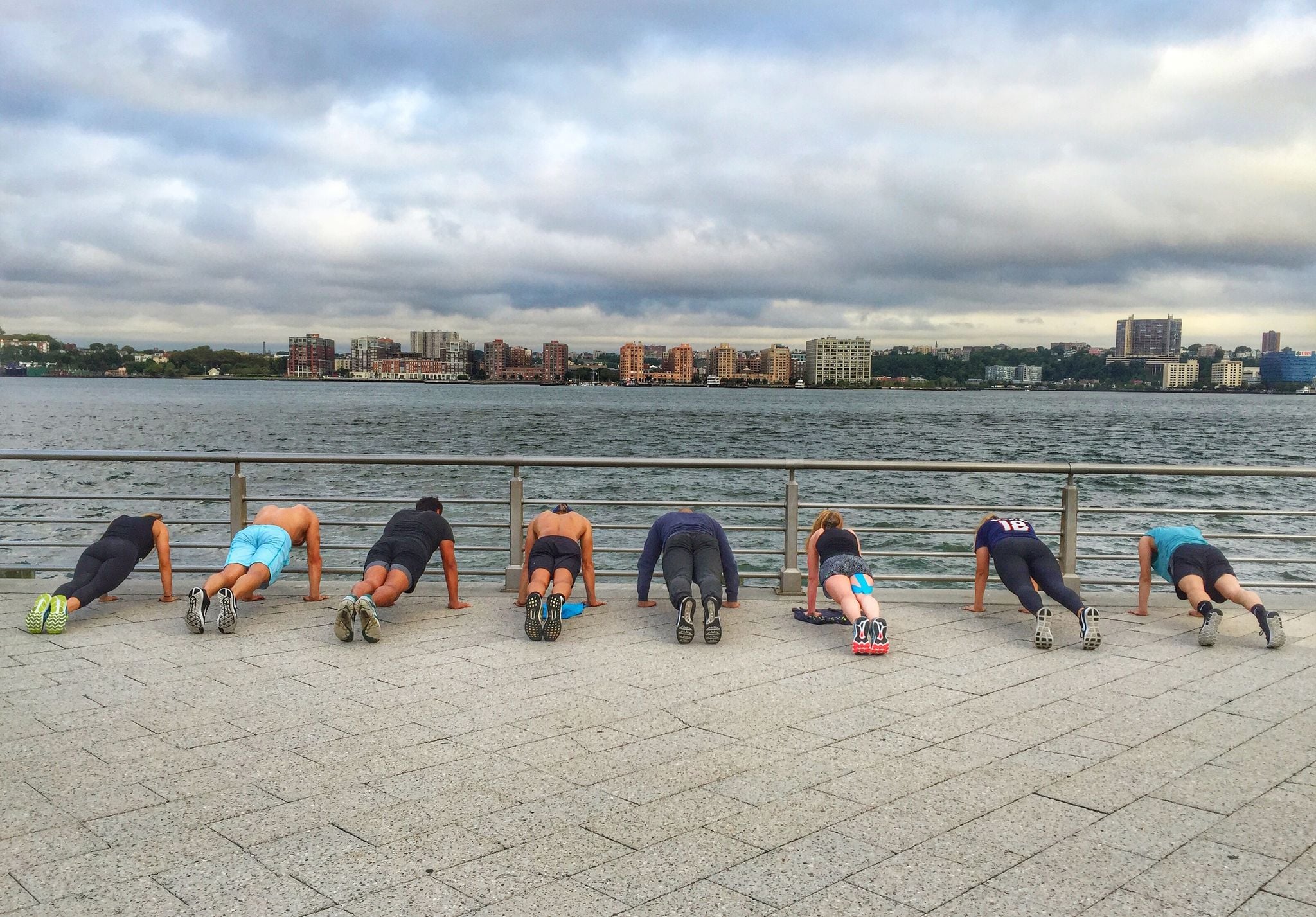 Push ups in a line facing the Hudson River