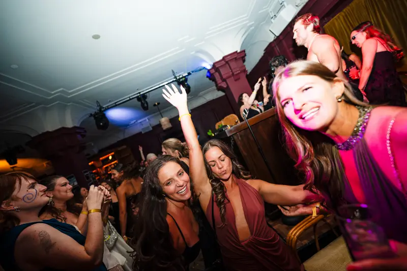 Friends dancing with their arms up