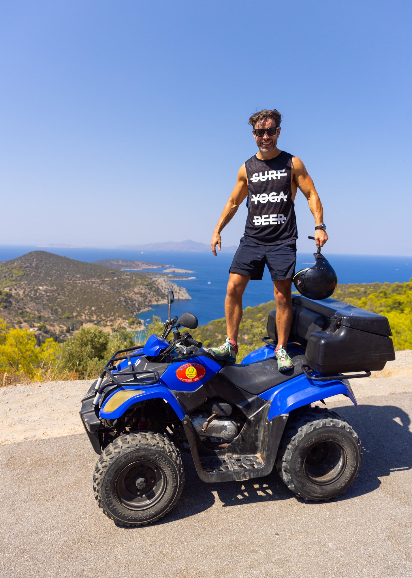 An SYB guest standing on an ATV above the sea on Poros