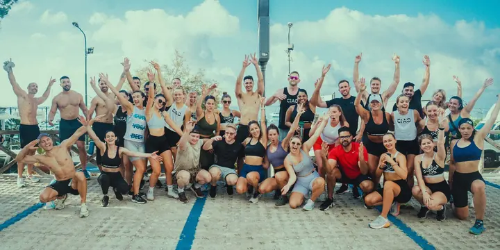 The whole crew with arms up after a morning workout on the SYB Amalfi Coast trip