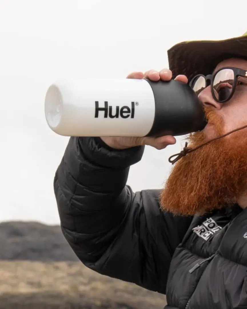Russ Cook drinking from a Huel bottle on Kilimanjaro