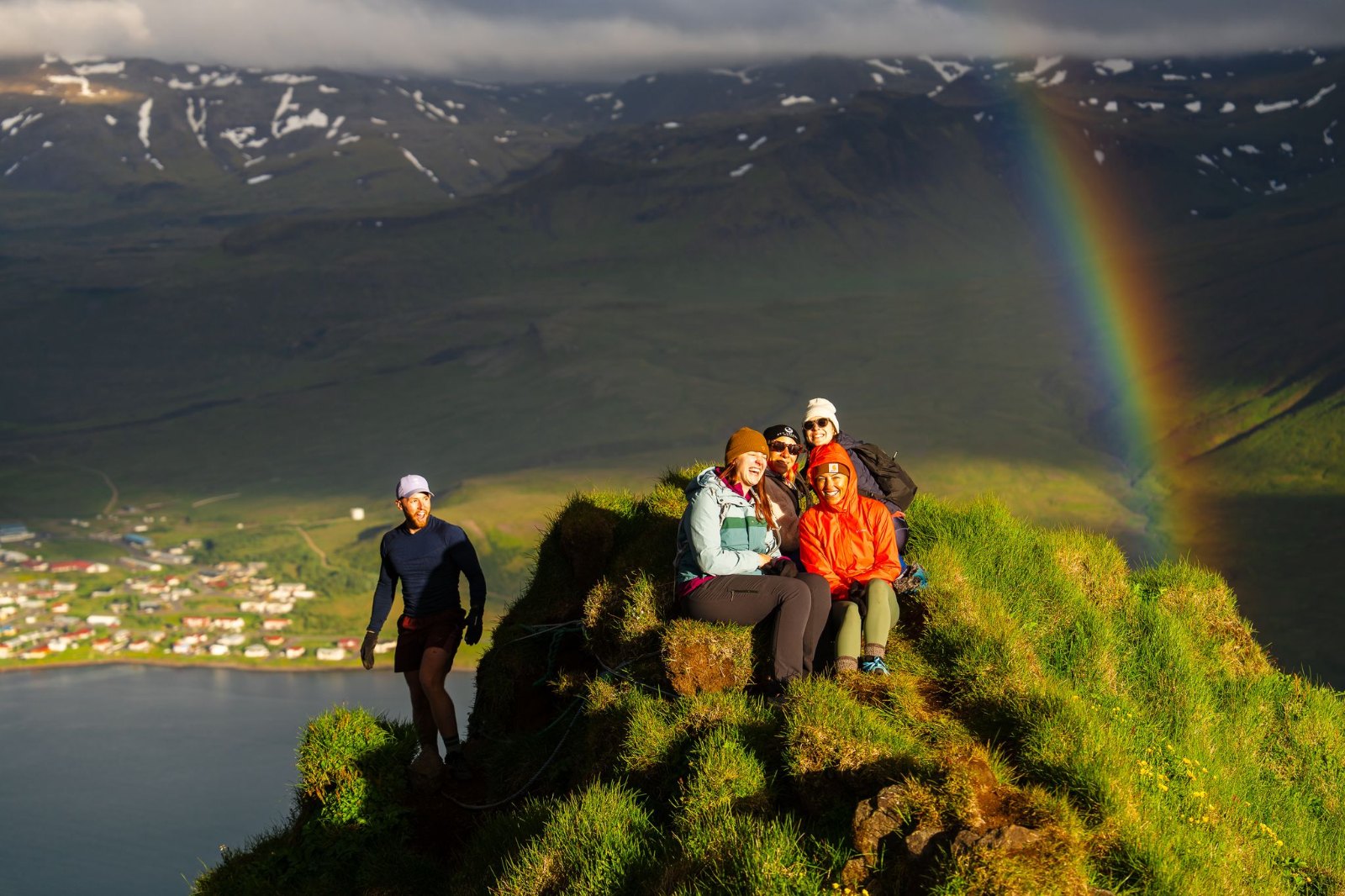 The SurfYogaBeer crew on a peak under a rainbow on Snæfellsnes