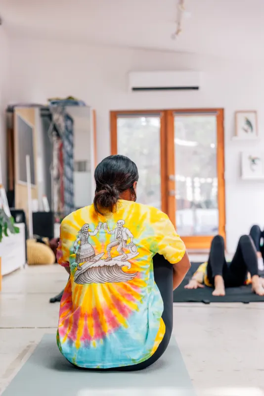 Stretching it out in the tie-dye shirt during Pilates
