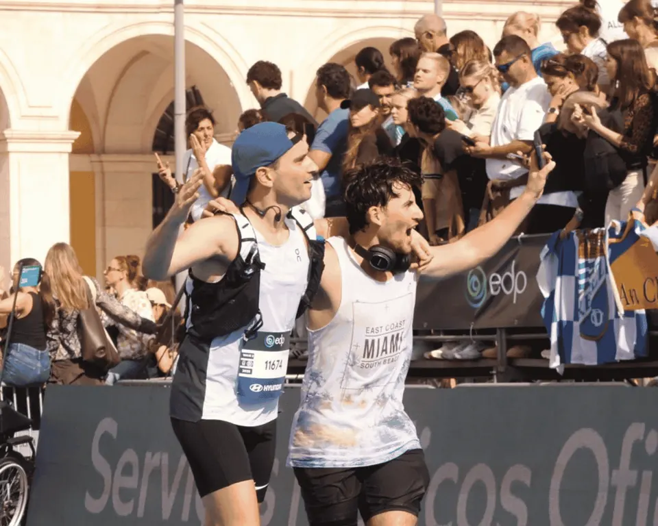 Two male runners pushing through the pain barrier during their Hardest Adventures marathon.