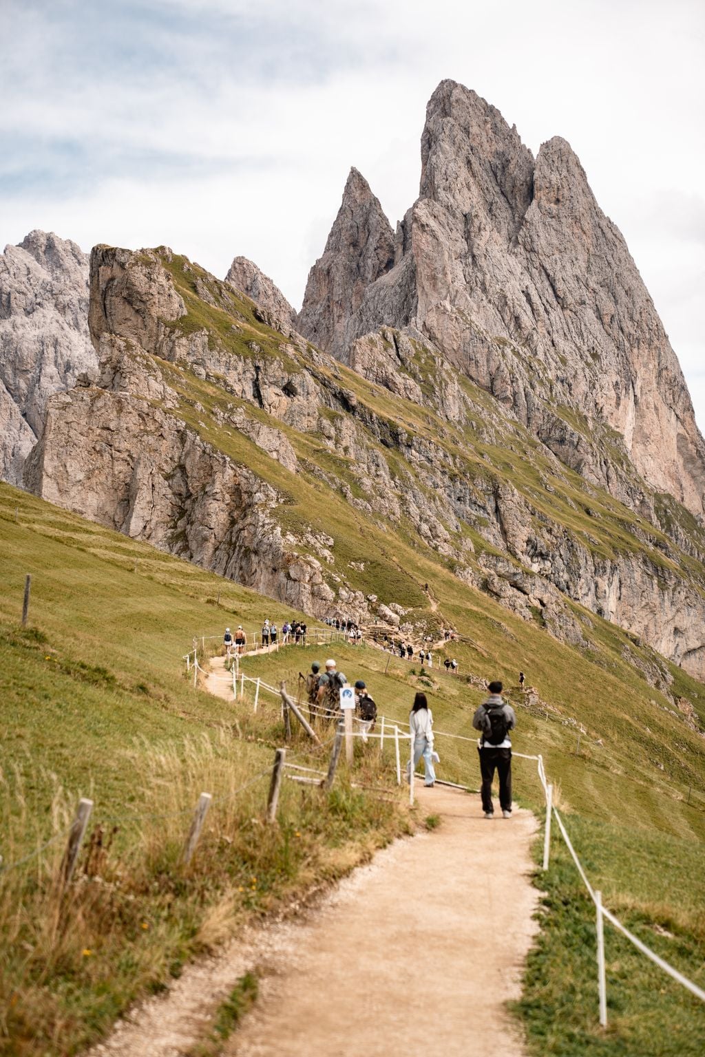 Hikers on the trail along the Seceda ridgeline in the Dolomites