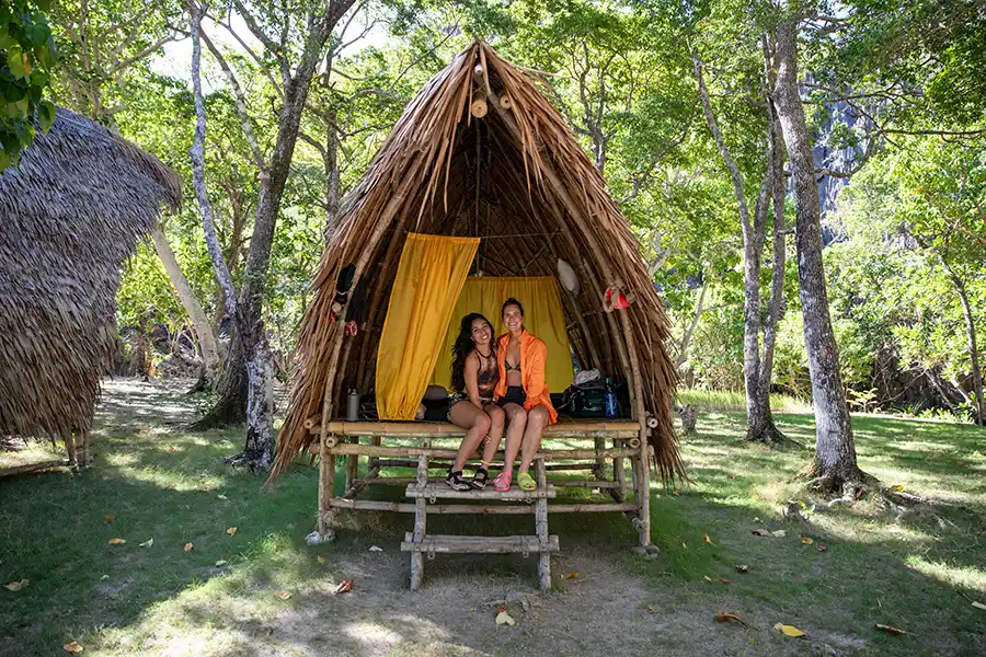 SurfYogaBeer crew at a long farm to table dinner table in the El Nido jungle