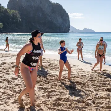 Group game on the sand with the sea behind on the SYB Philippines trip