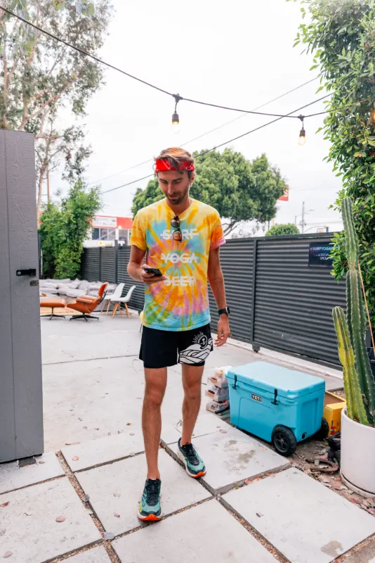 A runner in the tie-dye shirt back in the Milwood Studios courtyard