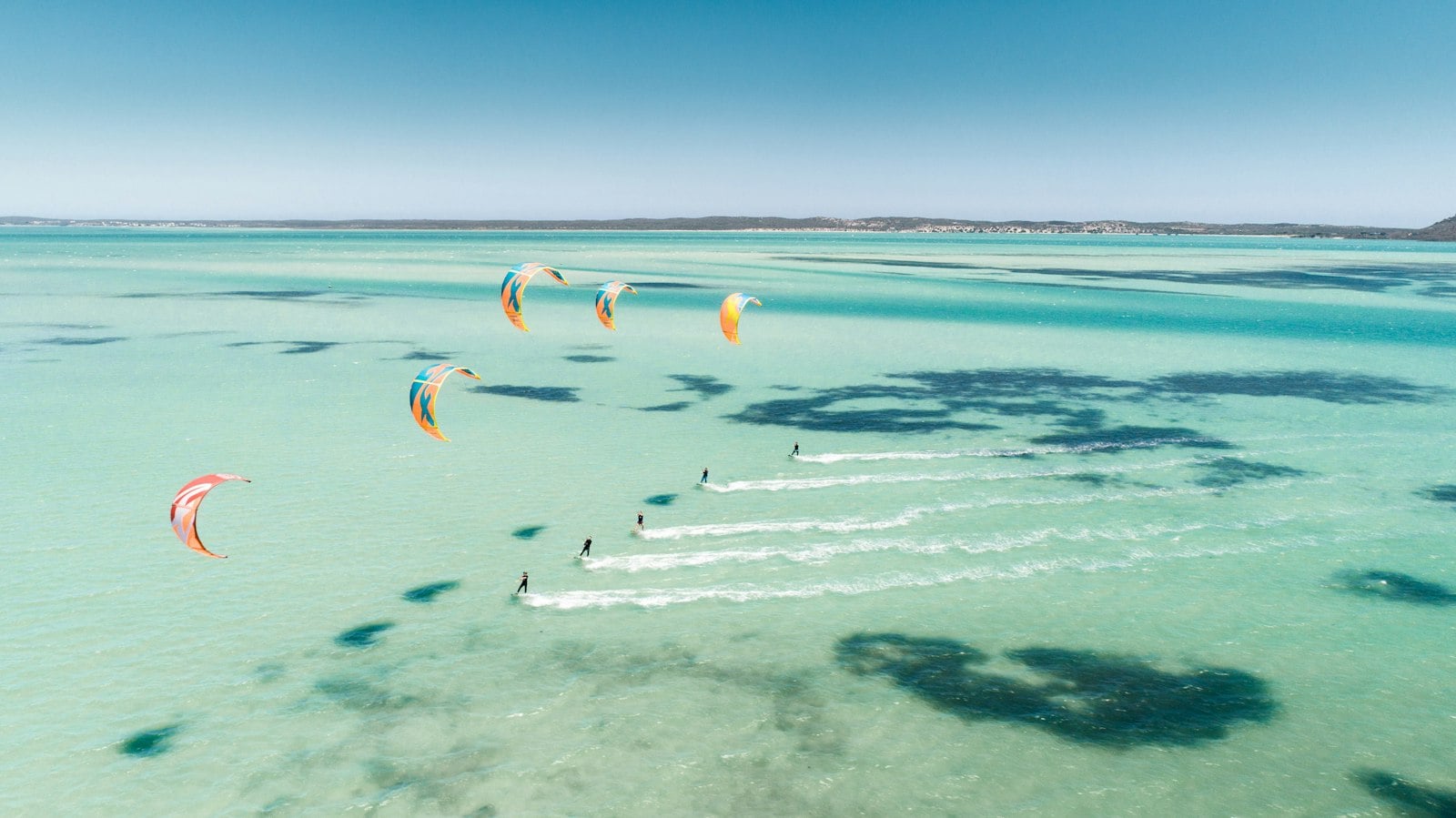 Kitesurfers on a turquoise Red Sea lagoon in Egypt