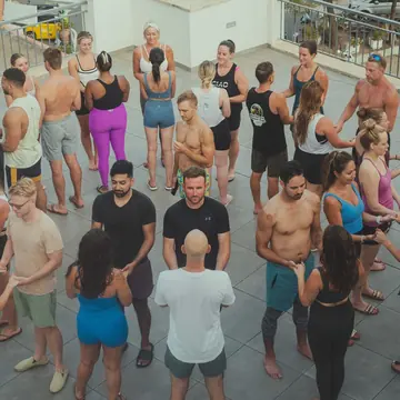 Partner warm up in a big circle on the rooftop on the SYB Amalfi Coast trip