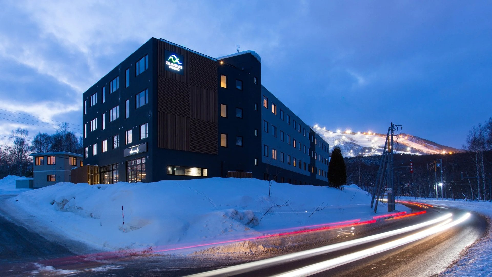 Always Niseko at night with the lit Grand Hirafu ski slopes behind it