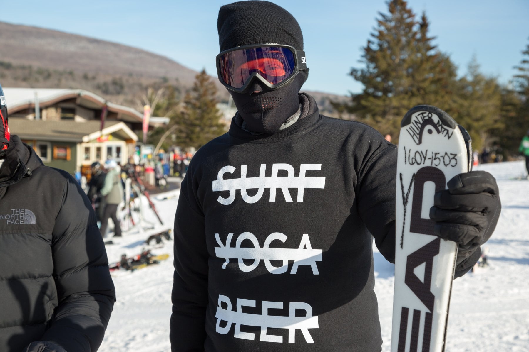 Snowboarder on an SYB Vermont trip wearing the black cross-out crewneck