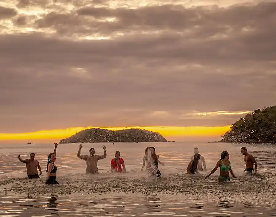 SurfYogaBeer crew silhouetted at sunset on a Philippines beach