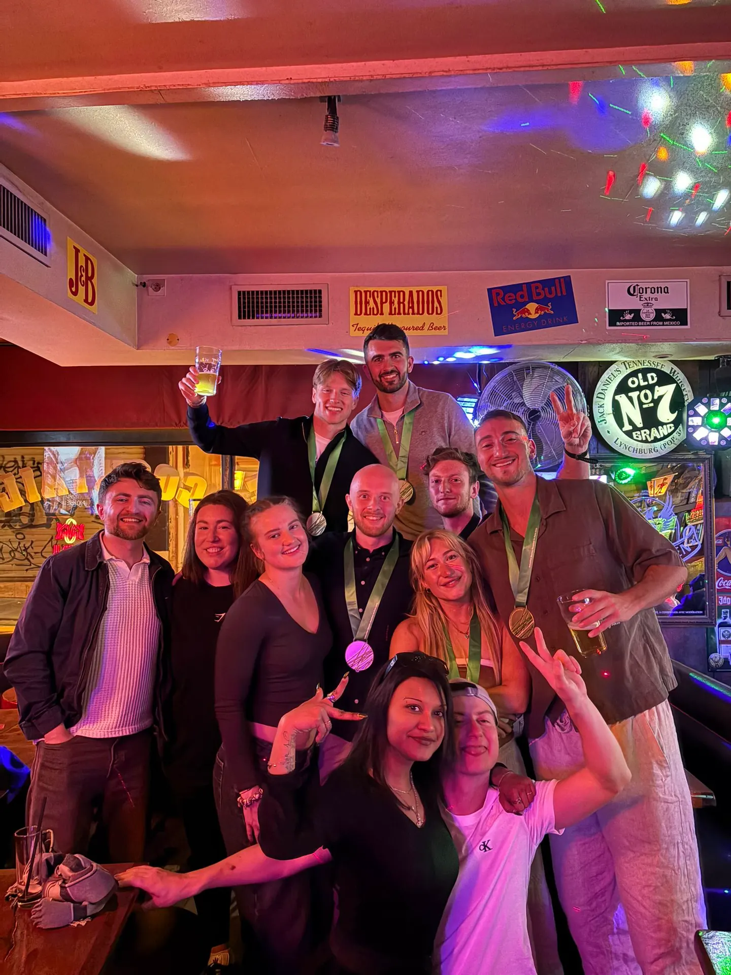 Hardest Adventures runners celebrating together after finishing the Paris Marathon.