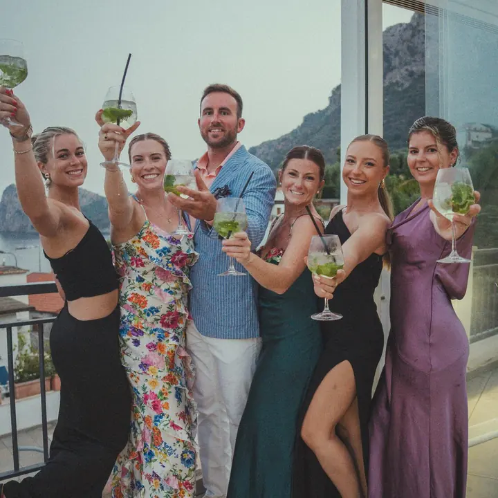 Dressed up and raising cocktails on the terrace at dusk on the SYB Amalfi Coast trip