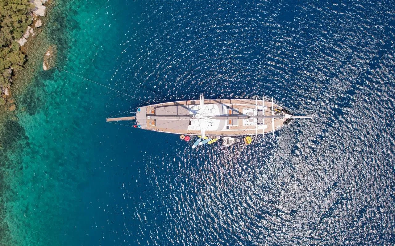Top-down drone shot of the gulet with the water toys lined up alongside