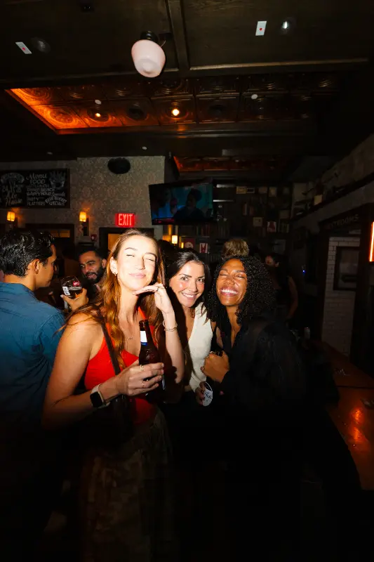 Three friends posing at the bar