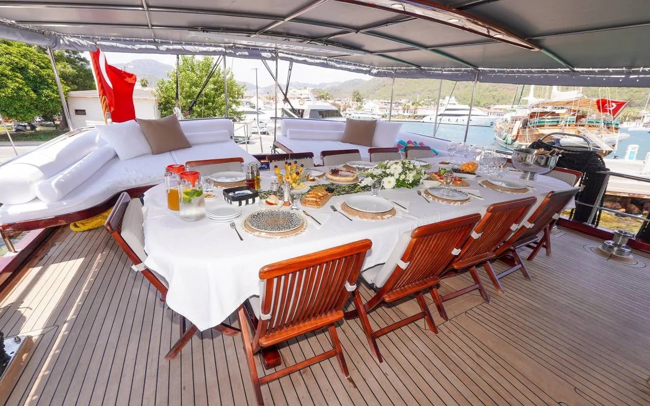 The long dining table on the shaded aft deck, set for lunch
