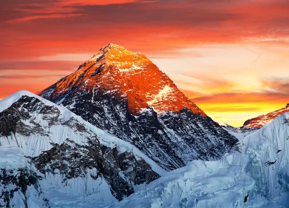 Kala Patthar glowing orange as the sun rises in the Himalayas.