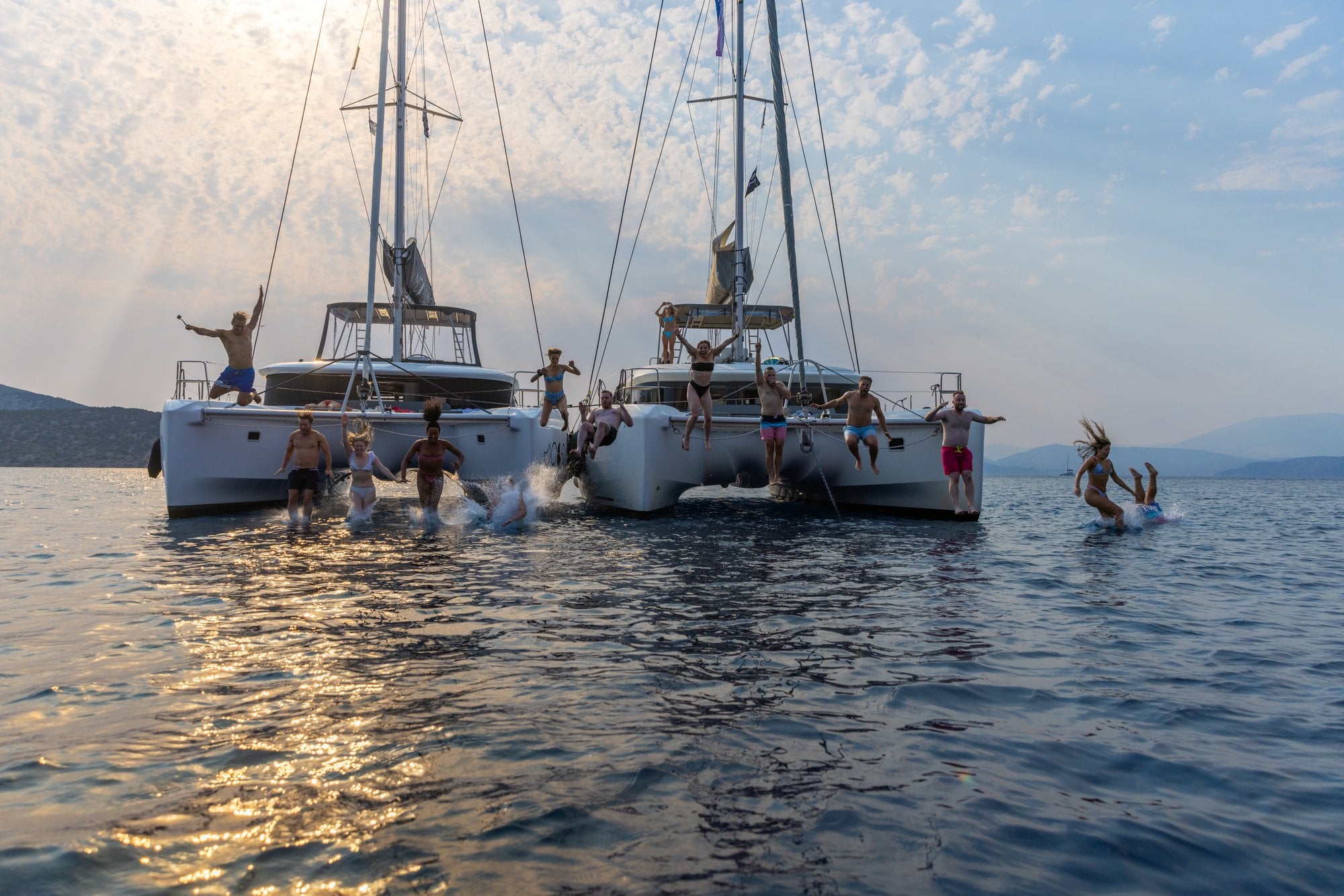 SurfYogaBeer catamarans rafted up together at sunset
