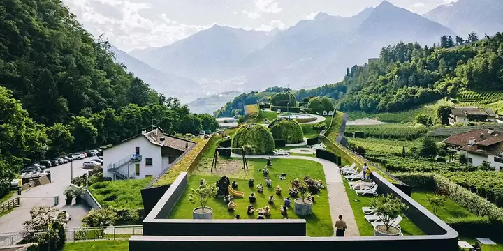 Group session on the hotel lawn seen from above with the valley behind on the SYB Dolomites trip