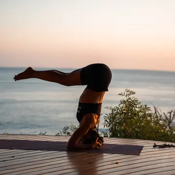 Yoga pose on the ocean deck at sunset in Nicaragua