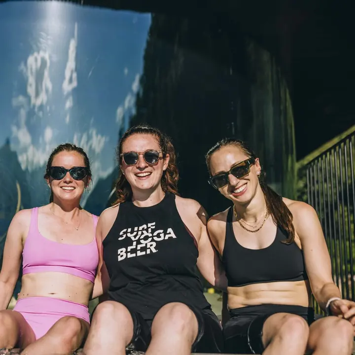 Three friends in sunglasses sitting by the spa on the SYB Dolomites trip