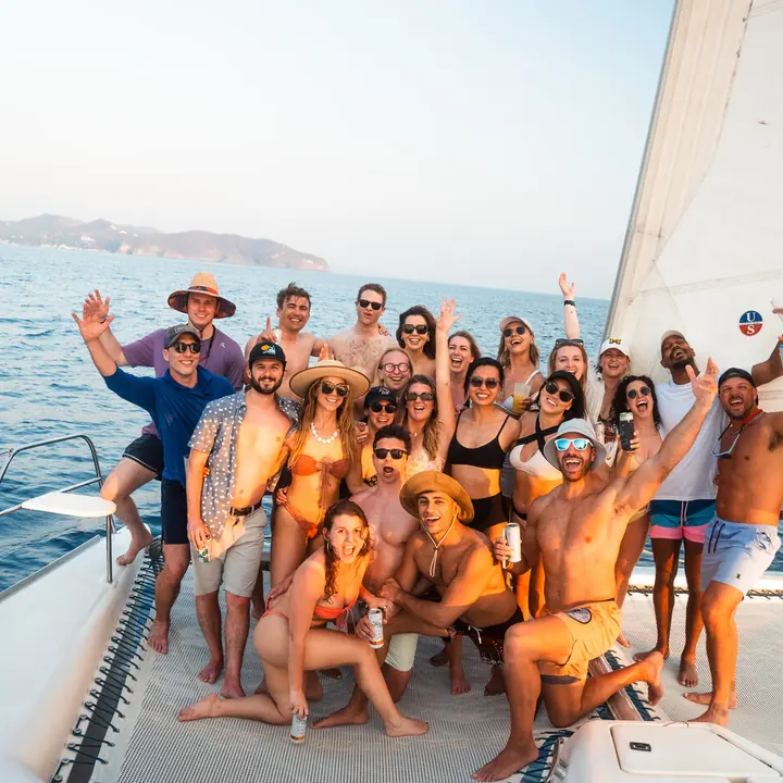 The whole SYB crew cheering on the bow of the catamaran on the SYB Nicaragua trip